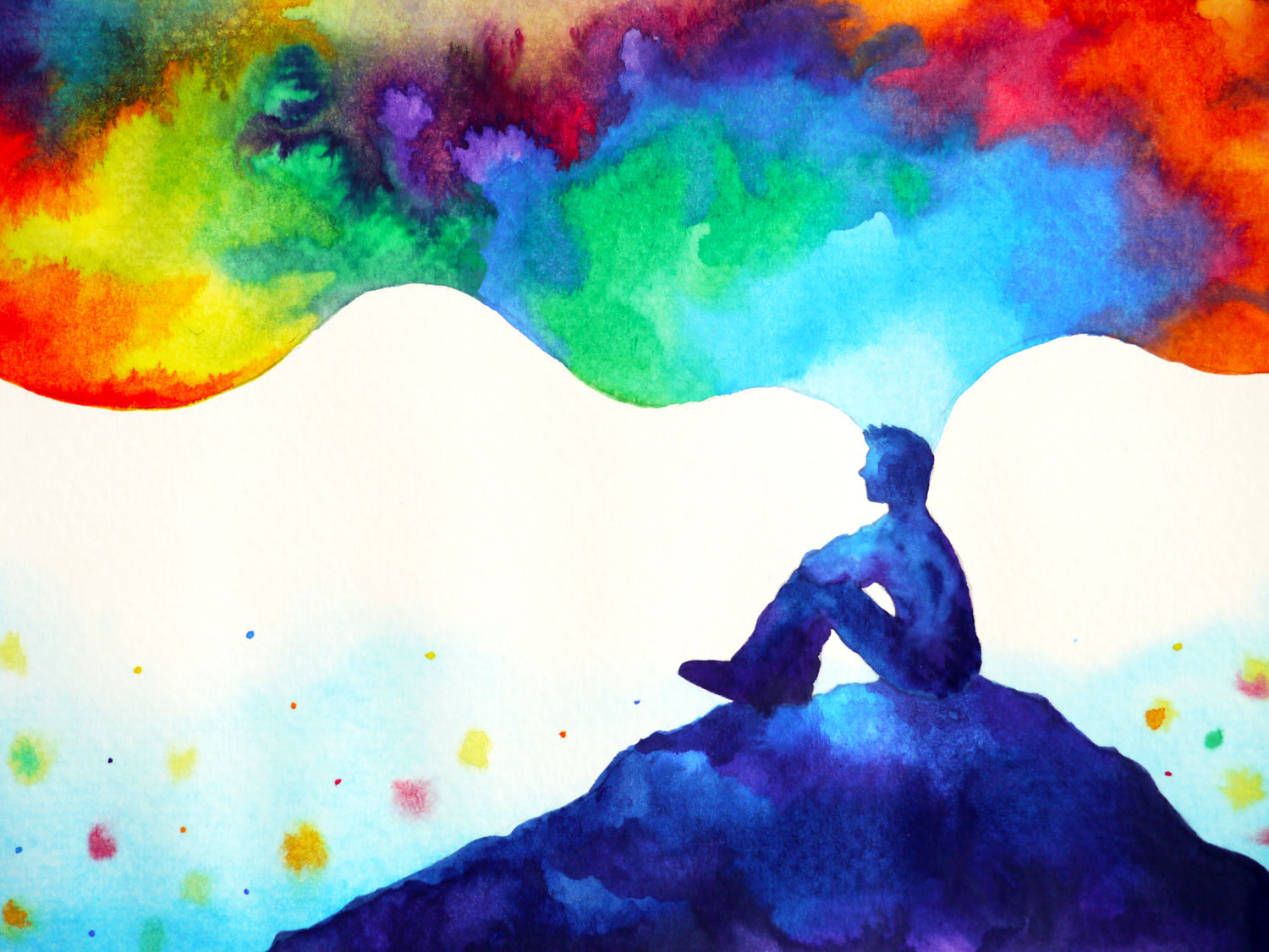 Man on hill surrounded by colours