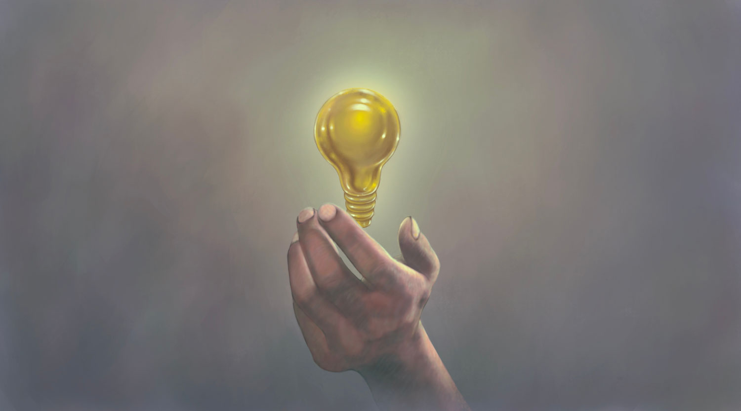 Hand holding a lightbulb